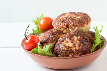 Homemade cutlets and lettuce leaves on a plate..Shallow DOF