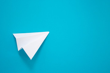 White paper plane on a blue background. Telegram symbol