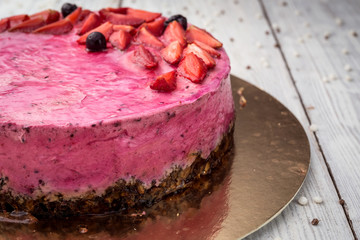 Strawberry Cake dessert with vanilla cream on wooden background