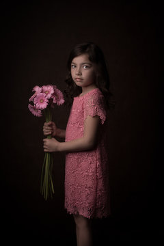 Painterly studio portrait of girl in pink with flowers