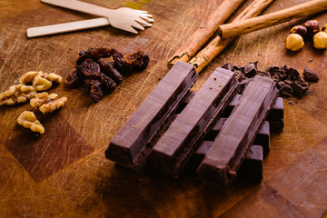 Plate of black chocolate chips with cinnamon and hazelnuts