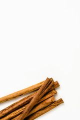 Stack of cinnamon sticks on white background and space