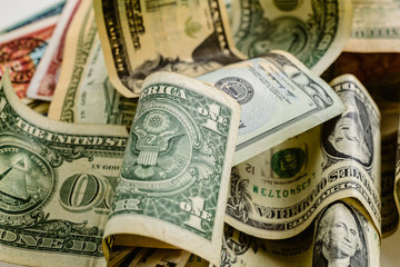 wad of dollar bills on a table