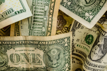 wad of dollar bills on a table