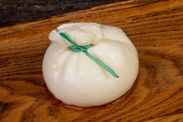 Burrata cheese over wooden