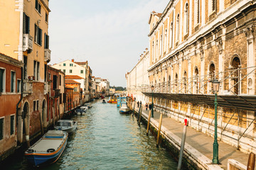 Fototapeta na wymiar Cityscape of Venice with buildings, channel and bridge, sky.
