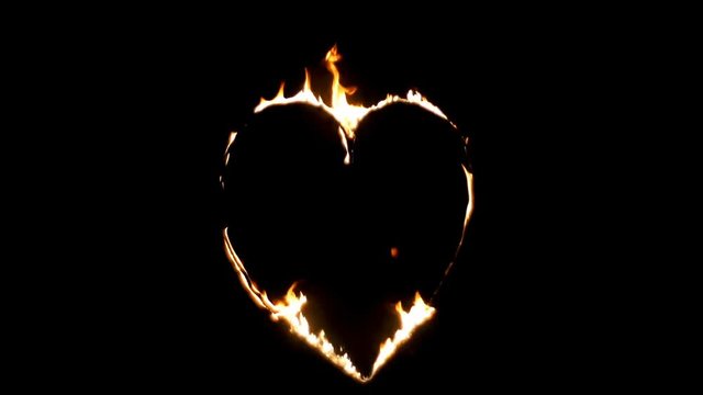 Burning heart of love. Fire show the wedding. Realistic Fire - Slow Motion.  Decorative flame - a symbol of passion. Real flames on a black background. You can easily using Add or Screen transfer mode