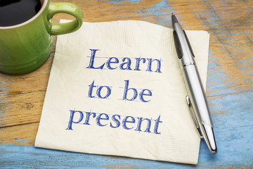 Learn to be present - text on napkin