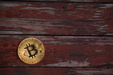 gold bitcoin sharp wooden background