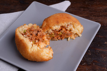 Arancina with meat on gray plate 