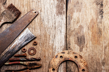 Old rusty tools on old wood background. vintage photo