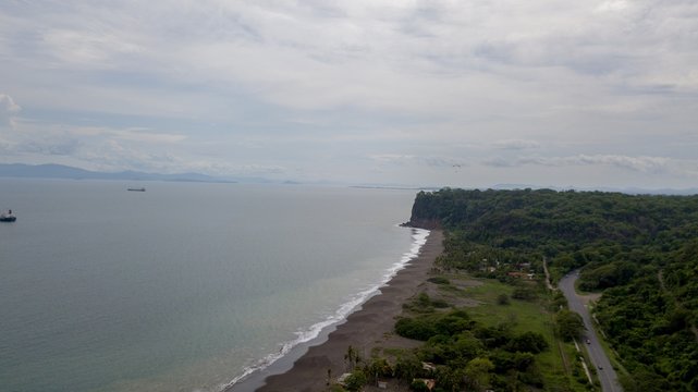 Beautiful aerial view of the beach with parapenting in the horizon