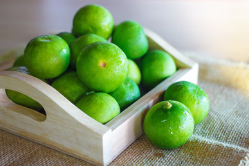 Fresh Citrus lime fruit in wooden box