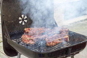Steak Cooking On An Open Grill