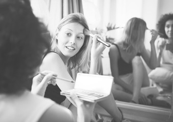 Women applying makeup on her face