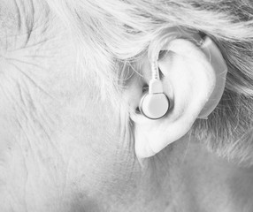 Elderly woman wearing a hearing aid