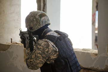 Special forces soldier holding rifle low angle digital camouflage uniform