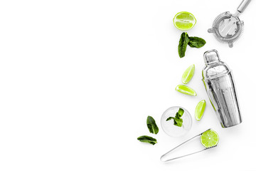 Process of making mojito concept. Ingredients and crockery. Slices of lime, mint, glass with ice...