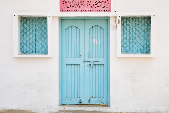 Blue door and window, house exterior in India