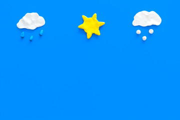 Clear, rainy, snow weather icons on blue background top view copy space
