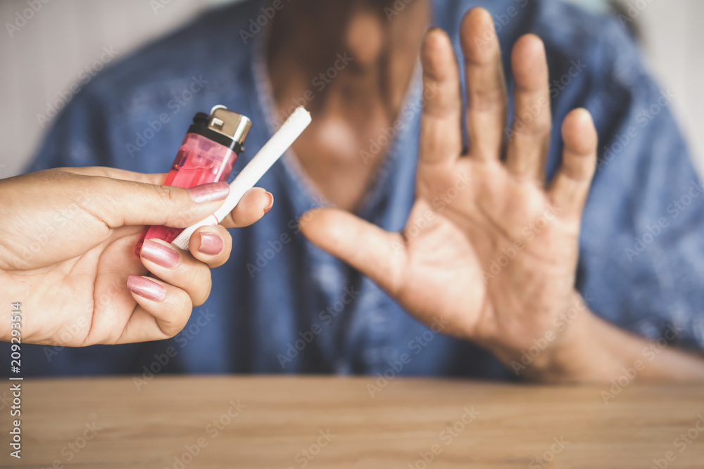 Wall mural old man hand refusing cigarette no more and stop smoking concept 