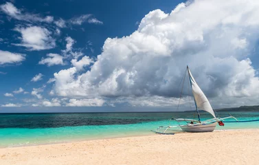 boat at white Puka beach of Boracay island Philippines