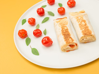 Cooked vegetarian tortillas on yellow background
