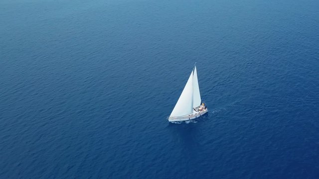 Yacht sailing on opened sea. Sailing boat. Yacht from drone. Yachting video. Yacht from above. Sailboat from drone. Sailing video. Yachting at windy day. Yacht. Sailboat.