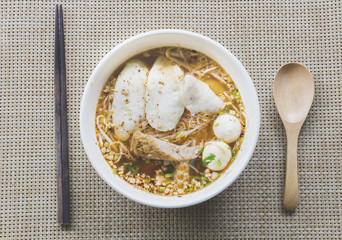 fish ball noodle with chopstick and wooden spoon