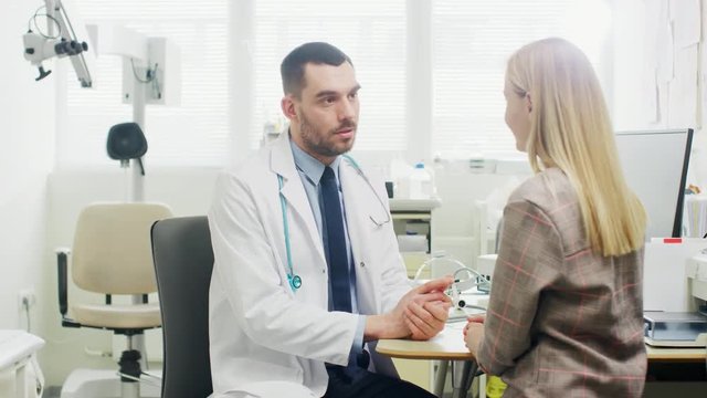 In Medical Office Concerned Doctor Talks with a Beautiful Blonde Woman. Health Care Professional Consultation in the Bright Modern Office. Shot on RED EPIC-W 8K Helium Cinema Camera.