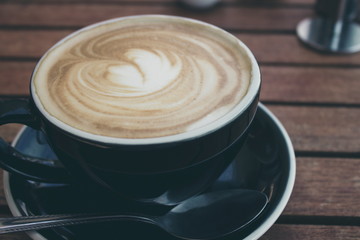 close up image of a hot cup of coffee in a black cup