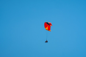 paragliding in blue sky, extreme sport