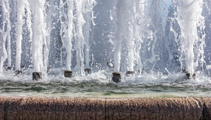 splashes of fountain water in a sunny day. natural background