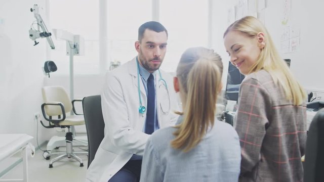 Mother with Her Cute Little Girl Have Doctor's Appointment