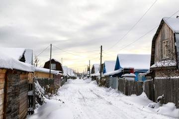 Russian village and wooden house in it in a winter
