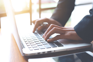 Business woman hand is working on a laptop computer in an office.