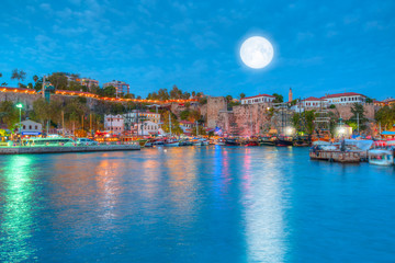 Aerial view of Old harbour with super moon at night . Old town is popular destination in Antalya "Elements of this image furnished by NASA "