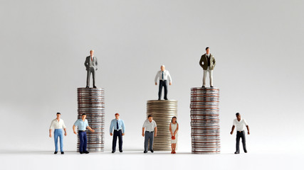 The stack of coins with miniature people.