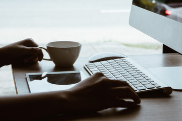 Fototapeta premium working day in office,workplace table and office desk close up hand hold on coffee cup