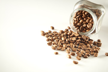 roasted coffee beans poured from clear glass