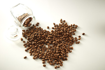 roasted coffee beans poured from clear glass