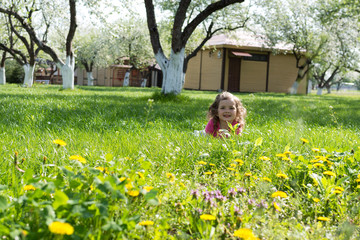 Little girl playing at the green lawn