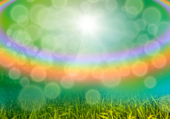 Fototapeta na wymiar Green grass background with bokeh and rainbow