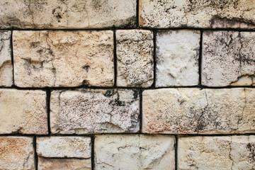 Closeup texture of brick aged wall in sand color outdoor