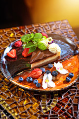 chocolate and nut cake with fruit in the restaurant