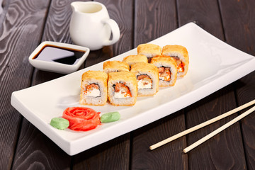 Sushi rolls on a plate with chopsticks and soy sauce. Japan cuisine.