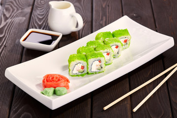 Sushi rolls on a plate with chopsticks and soy sauce. Japan cuisine.