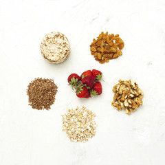Concept of healthy eating. Oat flakes, flaxseeds, strawberries, rice loaves, walnuts and raisins. Healthy food products.