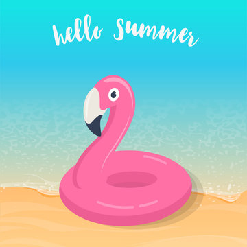 Hello summer. Pink flamingo inflatable pool float on the beach