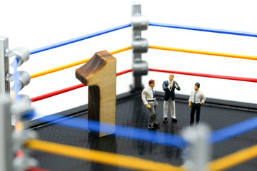 Miniature people : businessman with boxing gloves standing on boxing ring,  competition in the business concept.